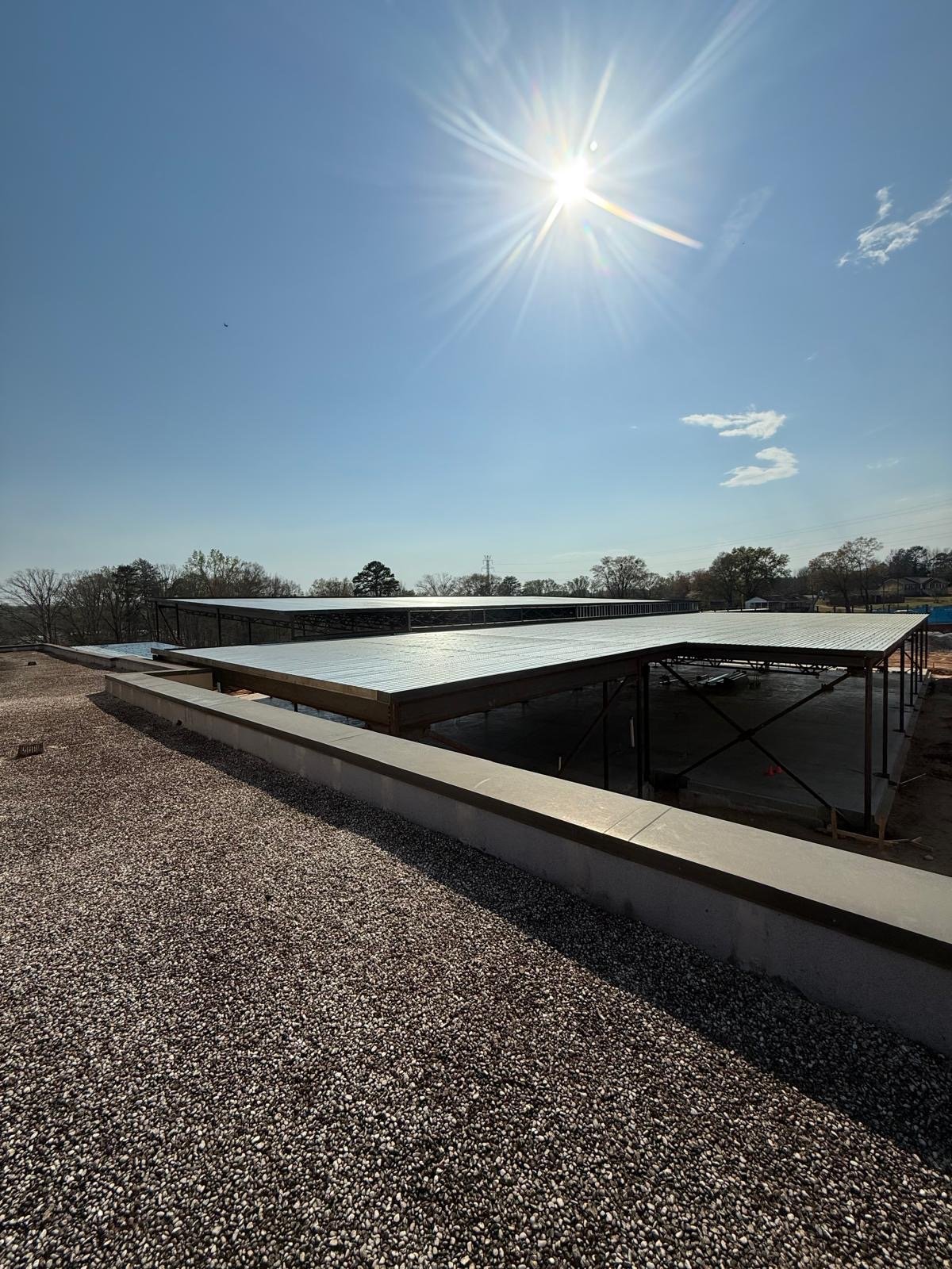 Metal roof deck installation under sun — A&W Welding NC